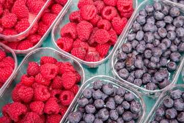 Fresh blueberry and raspberry in plastic box at market, © GoodPics