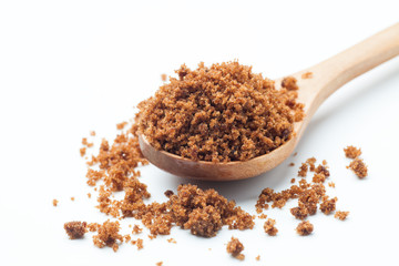 brown sugar with wooden spoon on white background