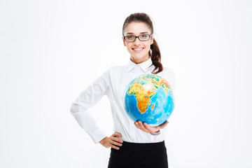 Cheerful pretty young businesswoman smiling and holding globe