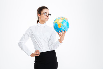 Pensive attractive young business woman holding earth globe