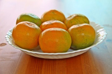 Asian orange or tangerine in white plate