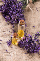 Obraz na płótnie Canvas spa massage setting, lavender product, oil on wooden background