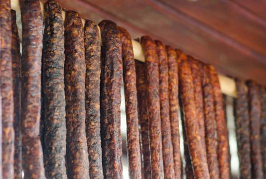 Romanian traditional sausages hanging on a wood stick