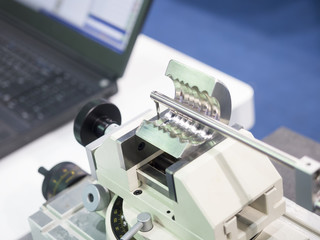 operator inspection automotive part by contour measuring machine