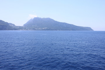 View of the island of Capri from the Tyrrhenian Sea in clear weather. Campania, Italy.