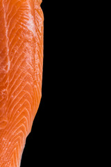 Fresh salmon fillet isolated on black background