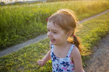 Girl running on the field  summer sunset