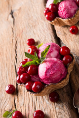 Sour cherry sundae with fresh fruits on wooden background. Sweet and summer concept