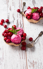 Sour cherry sundae with fresh fruits on wooden background. Sweet and summer concept