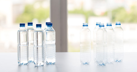 close up of bottles with drinking water on table