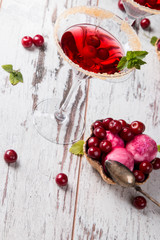 Sour cherry cocktail with fresh fruits on wooden background. Sweet and summer concept