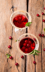 Sour cherry cocktail with fresh fruits on wooden background. Sweet and summer concept