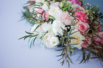 Flower arrangement on the table. Flowers and white tablecloth, wedding, roses, peonies