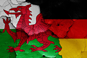 flags of Wales and Germany painted on cracked wall