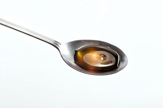 Honey drops on a spoon