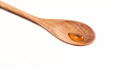 Tiny drops of honey in a  spoon