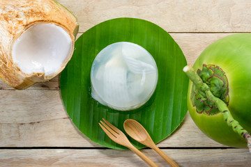 coconut jelly and wooden spoon on wooden background