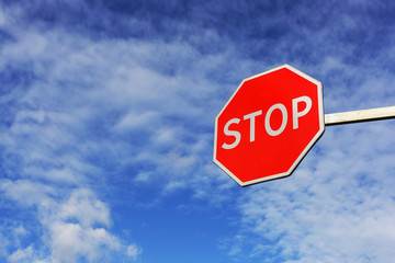 Bright road stop sign. Hanging side