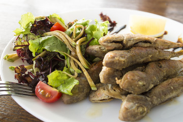small sea fish, fried in breadcrumbs with mixed salad