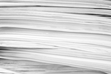 Stack of business report paper files on desk