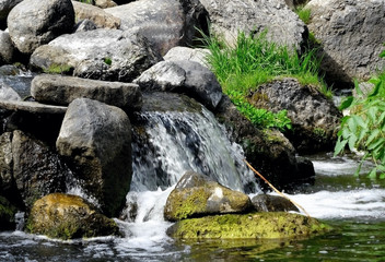 Naklejka na ściany i meble Rapids between rocks at the mountain river 
