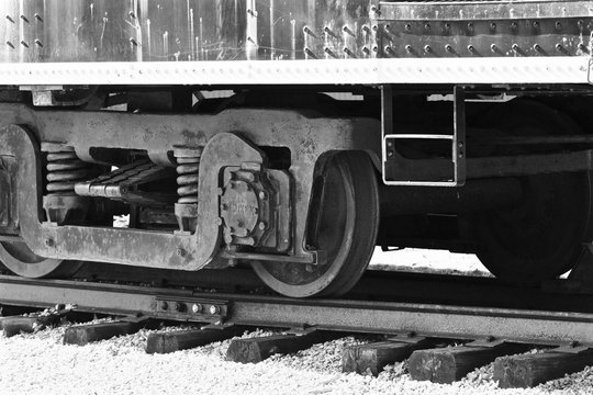 Beautiul black and white image of the train wheels