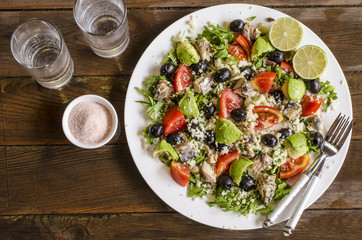 Couscous salad with tomatoes and arugula fish olives avocados   