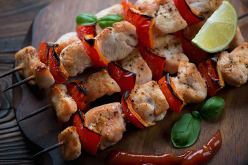 Close-up of barbecued skewers with chicken fillet and vegetables