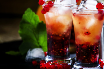 Alcoholic cocktail summer fizz with orange and redcurrant, selec