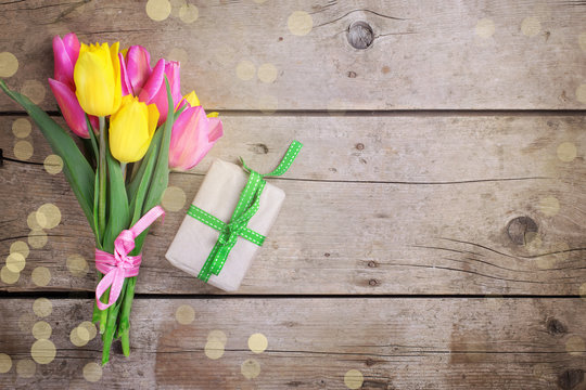 Background with bright yellow and pink spring tulips flowers and