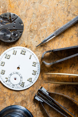 Various horologists tools with a clock dial