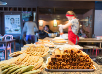 different types of sweet pastries on plates in cafe