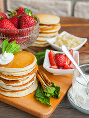 Pancakes on a wooden table with berries
