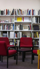 Modern library interior with red chairs