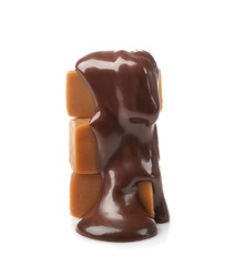 Melted chocolate with caramel candies, isolated on white
