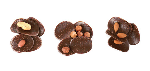 Chocolate chips and different nuts on white background