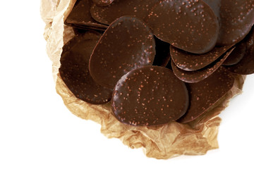 Chocolate chips in parchment on white background