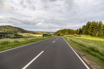 rural Eifel landscape with road and green meadow