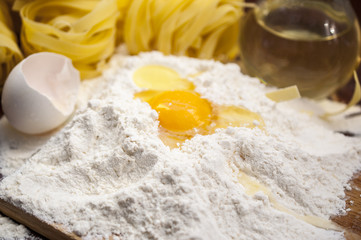 Obraz na płótnie Canvas Flour and Egg on the wooden table at a kitchen