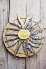 Delicious grilled sardines on wooden