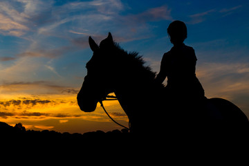 Silhouetted Horse Rider At Sunset