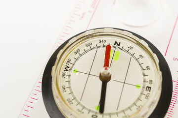 Detail shot of a glass compass on white background