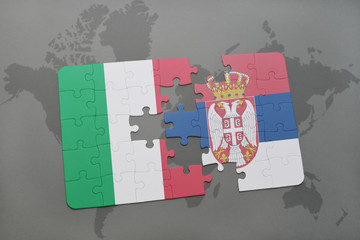 puzzle with the national flag of italy and serbia on a world map background.