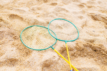Fototapeta na wymiar Badminton rackets in the sand of the beach