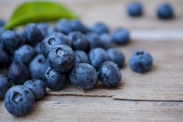 Blueberry on the wooden table with a spoon at a kitchen in village
