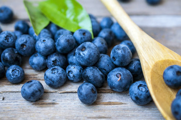 Blueberry on the wooden table with a spoon at a kitchen in village