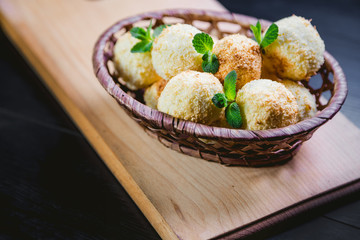 Coconut cookies in a basket with mint, a tasty dessert