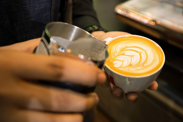 Barista pouring streamed milk