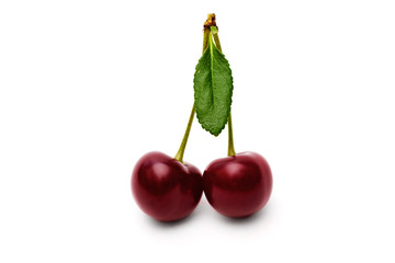 Two cherry with leaves isolated on white background.