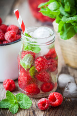 Cold drink with straw - raspberries summer refreshing cocktail.
